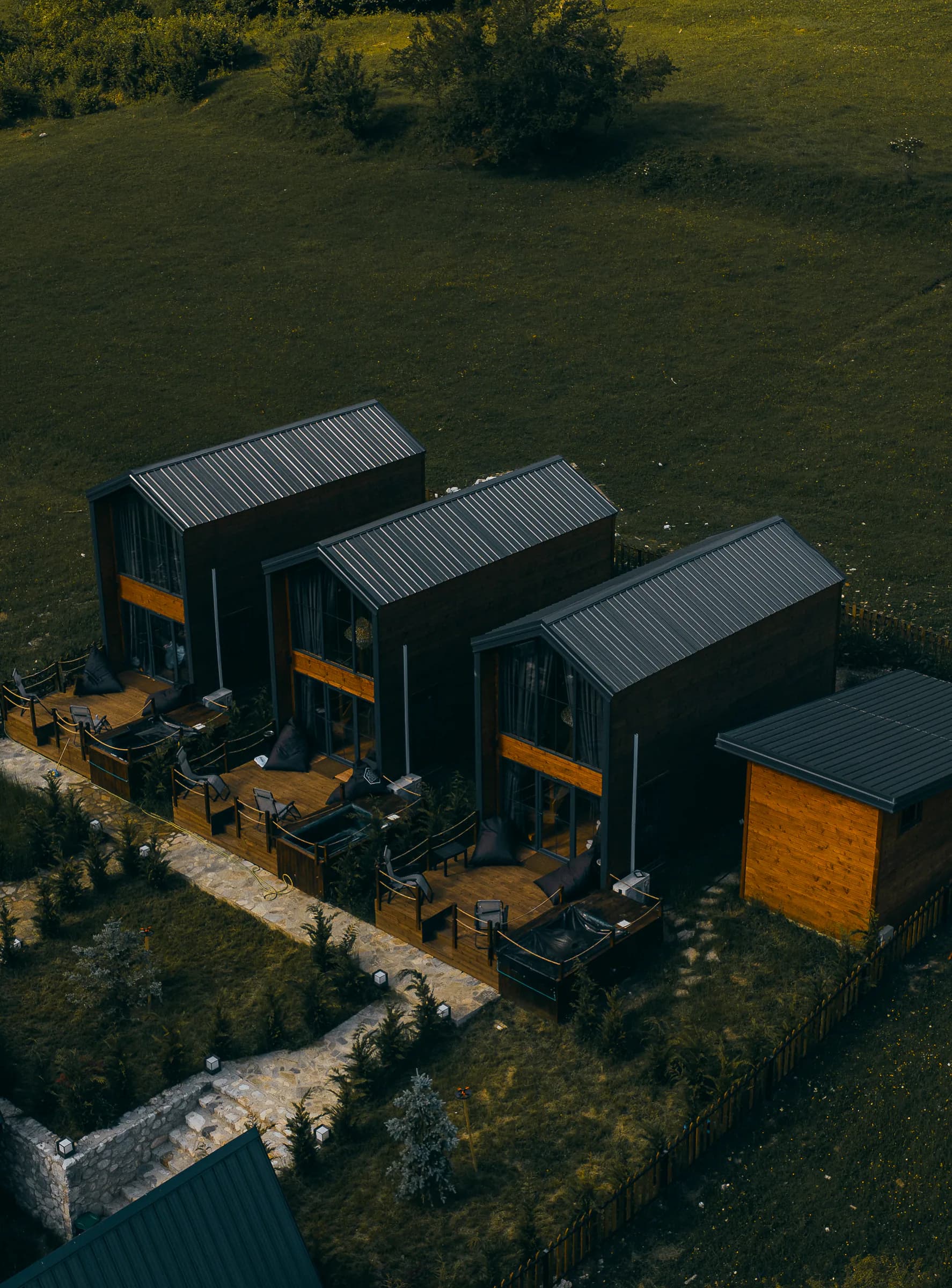 Aerial view of the dark timber cabins at SeSam Villas