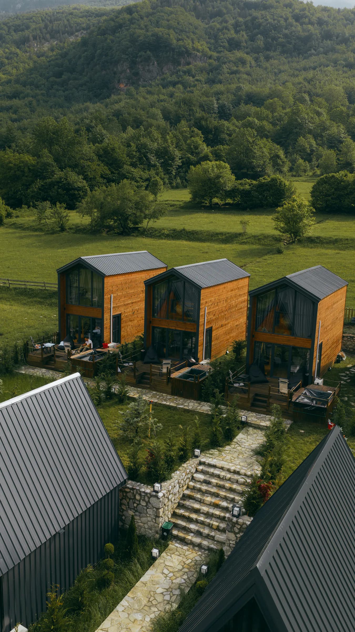 SeSam Villas set among green fields and forested mountains