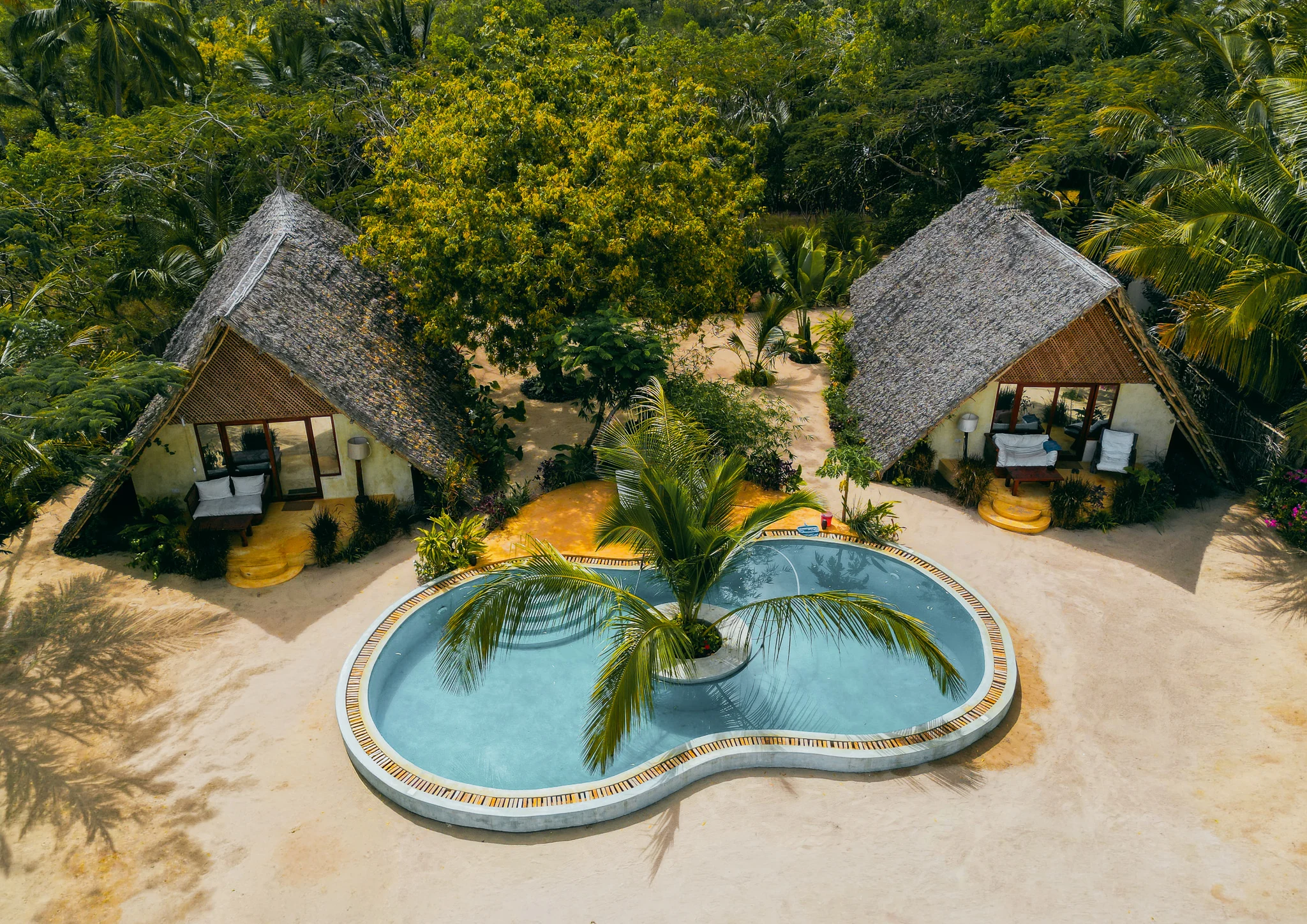 Aerial view of tropical villas surrounding a swimming pool